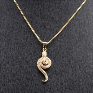 Close-up of golden snake pendant necklace with micro-pave crystals on box chain
