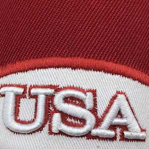 Close-up of USA embroidery on high-quality red twill fabric for a baseball cap