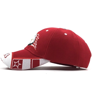 Red USA baseball cap with eagle embroidery and star patterns in a side view