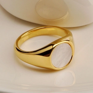 Minimalist gold signet ring with a round white shell inlay and high polish finish