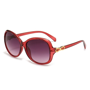 Retro translucent red oval sunglasses for women with golden bow detail and purple lenses