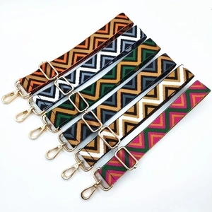Adjustable woven shoulder straps with geometric zigzag patterns and gold metal hardware
