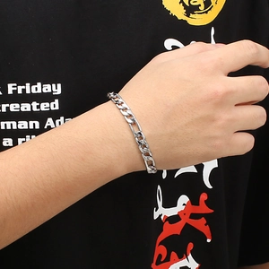 Classic silver stainless steel curb chain bracelet shown on a male wrist