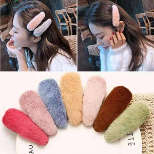 Plush faux fur hair clips in seven different colors shown on models and flat lay