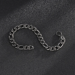 Retro stainless steel Figaro chain bracelet for men and women on black leather background