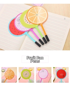 Detail of creative fruit-shaped fan pens in watermelon and kiwi designs on a notebook