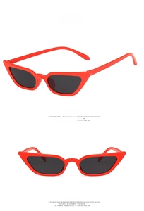 Detailed front and side views of slim cat-eye sunglasses in vibrant red with grey lenses