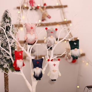 Set of 6 colorful Christmas gnome ornaments hanging on a decorative white branch