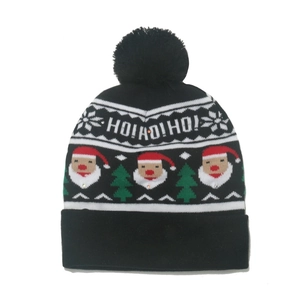 Detail of black knit Christmas beanie with HO! HO! HO! text and Santa festive patterns