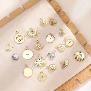 Macro shot of assorted Evil Eye and celestial gold-plated pendants for DIY jewelry