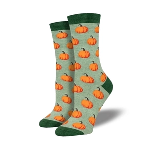 Detail of green mid-calf socks featuring orange pumpkin knit patterns for Halloween
