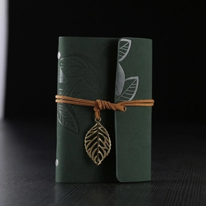 Vintage dark green leather notebook with leaf embossed cover and bronze pendant strap