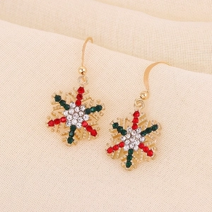 Detailed view of Christmas snowflake drop earrings with red and green rhinestones