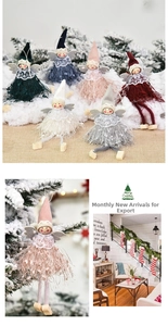 Detail of Christmas angel dolls with lace collars and soft feather wings hanging on a tree