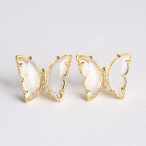 Detailed view of butterfly stud earrings with gold plating and clear faceted wings