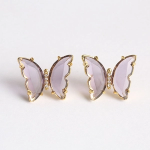 Detailed view of lilac butterfly earrings with glass wings and gold-plated frames