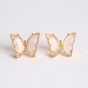 Detail of pink butterfly earrings with gold metal frame and sparkling crystal accents