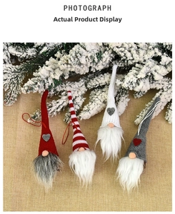 Close-up of four knitted Christmas gnomes with heart patterns and plush white beards