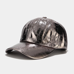 Detailed view of silver metallic textured fabric on a street style baseball cap
