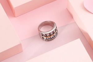 Macro detail of wide 304 stainless steel ring with gold accents and zircon stones