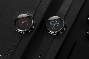 Detail view of two stylish men's quartz watches with mesh straps and date function.