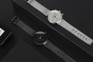 Detailed view of fashion men's quartz watches with Milanese mesh straps and three-eye dials