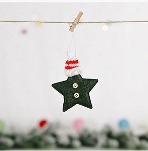 Close-up of green felt star ornament with red striped knit hat and wood buttons