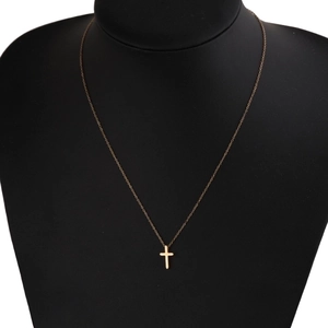 Polished minimalist gold cross pendant necklace on black neck display for men and women