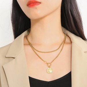 Detail of 18k gold double-layer necklace with crown relief pendant and OT buckle style