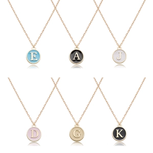 Golden alloy alphabet pendants with colorful enamel inlay in a grid display