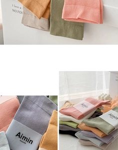 Detail of Morandi colored cotton mid-tube socks with minimalist paper brand packaging