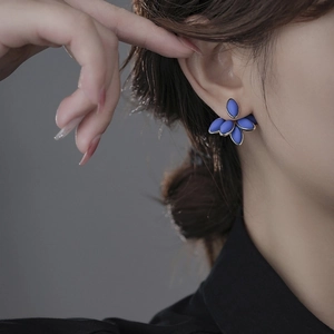 Elegant vintage blue floral earrings for women shown on model for artistic look