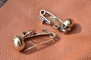 Gothic skull and ribcage skeleton brooches in vintage bronze finish on leather