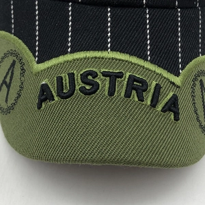 Detail of pinstripe cotton fabric and green AUSTRIA embroidery on the baseball cap