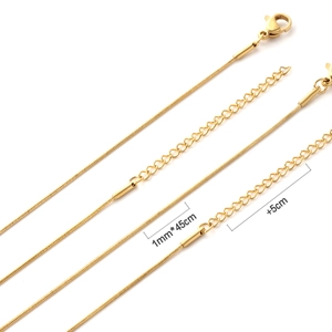 Close-up of 1mm gold snake chain necklace with lobster clasp and 5cm extension chain