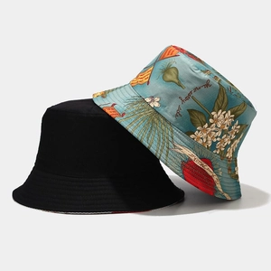 Detail view of reversible sun hat showing black solid side and light blue floral print