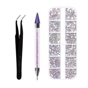 Detail view of nail art dotting tool set with tweezers, wax pen, and rhinestones