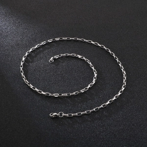 Minimalist silver rectangular box chain necklace in stainless steel on black background