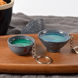 Creative Mengpo Soup bowl keychain with green liquid resin in a minimalist vintage style