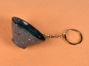 Detailed macro view of the creative miniature bowl keychain with dark blue resin interior