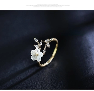 Detail showing artificial mother-of-pearl rose and zircon inlay on rose gold ring