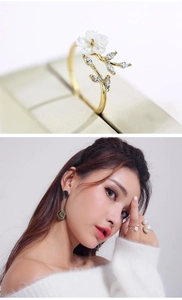 Detail view and model shot of golden flower ring with leaf and small gemstones