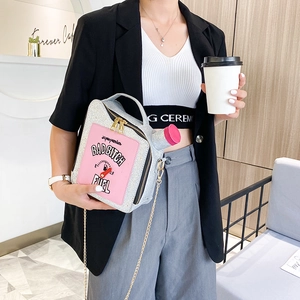 Creative silver sequin fuel can bag with chain strap shown in a modern cafe setting