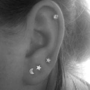 Stainless steel stud earring set with star moon and round crystal shapes on ear