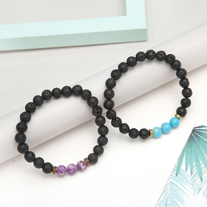 Detail of lava stone bracelets with blue turquoise and purple pattern bead accents