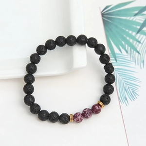 Detail of lava stone beads and purple jasper accents on an elastic beaded bracelet