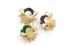Detail showing the golden alloy back and pin clasp of colorful bee brooches