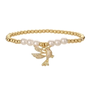 Elegant gold bead and pearl bracelet featuring a sparkling rhinestone bird charm