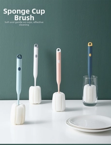 Detail of long-handled sponge brushes in four colors with hanging holes for cup cleaning