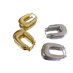 U-shaped woven hoop earrings in gold and silver finish with textured threaded design